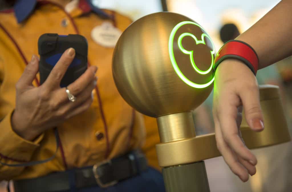 A Walt Disney World Resort guest uses a MagicBand to enter Magic Kingdom theme park in Lake Buena Vista, Fla. Guests also can use MagicBands to enter their Disney Resort hotel room, buy food and merchandise, enter Walt Disney World Resort theme parks and water parks, access their selected FastPass+ experiences and connect to Disney's PhotoPass. MagicBands are part of the new MyMagic+, which has the ability to connect nearly all aspects of the guest vacation experience at Walt Disney World Resort. (Kent Phillips, photographer)