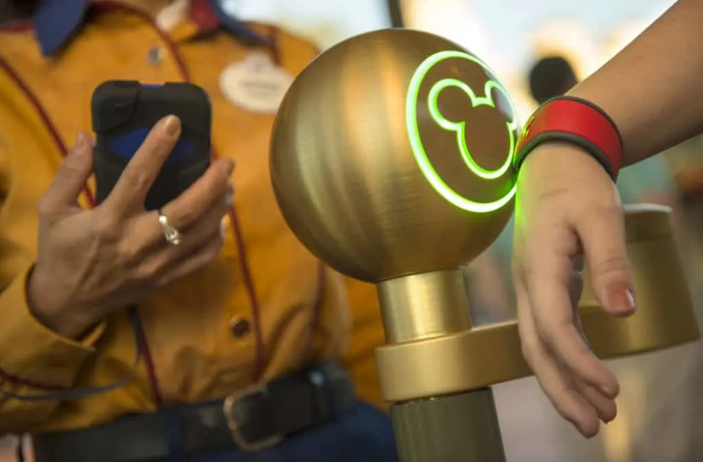 A Walt Disney World Resort guest uses a MagicBand to enter Magic Kingdom theme park in Lake Buena Vista, Fla. Guests also can use MagicBands to enter their Disney Resort hotel room, buy food and merchandise, enter Walt Disney World Resort theme parks and water parks, access their selected FastPass+ experiences and connect to Disney's PhotoPass. MagicBands are part of the new MyMagic+, which has the ability to connect nearly all aspects of the guest vacation experience at Walt Disney World Resort. (Kent Phillips, photographer)