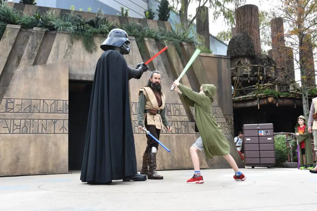 Learn all about Jedi Training at Walt Disney World and these easy tips and tricks that you can use to make sure your kids get to battle the dark side. #starwars #disneykids